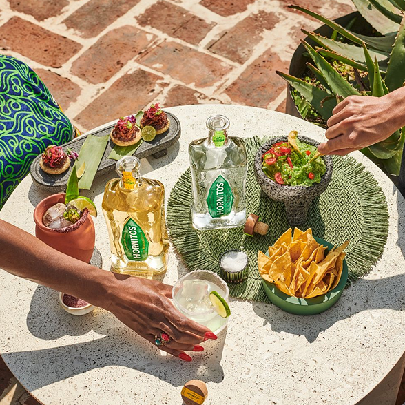 Tequila Bottles Guacamole Chips Cocktails Outdoor Table Hornitos