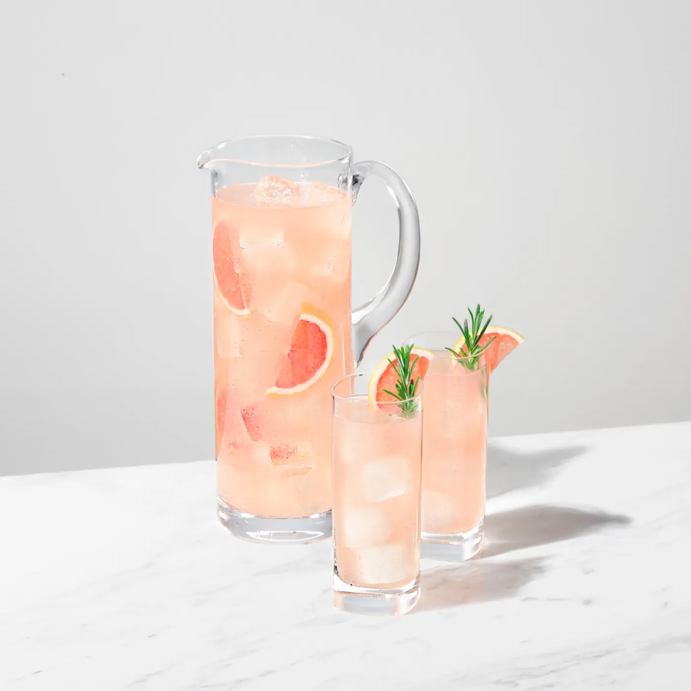 Image of a Jug and 2 glasses filled with Paloma Pitcher cocktail