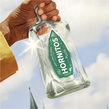 Hold empty plata bottle in hand.
