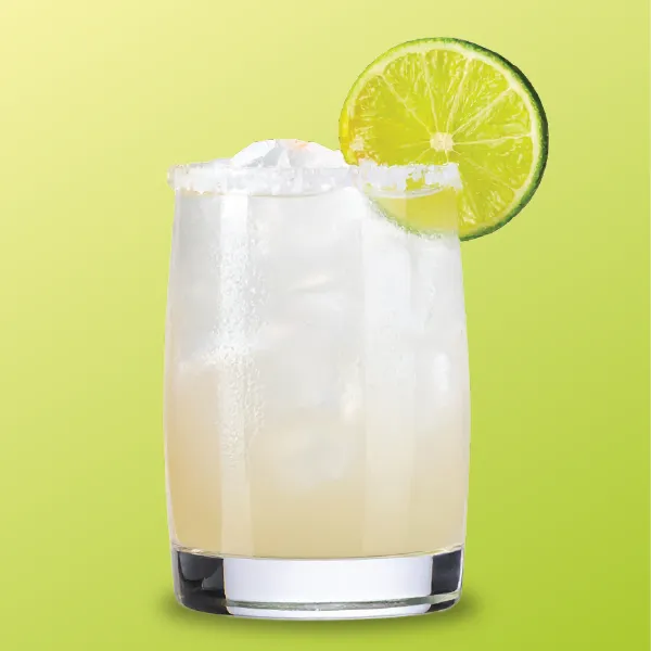 A refreshing margarita in a glass with ice, salted rim, and a lime wedge, set against a vibrant green background.