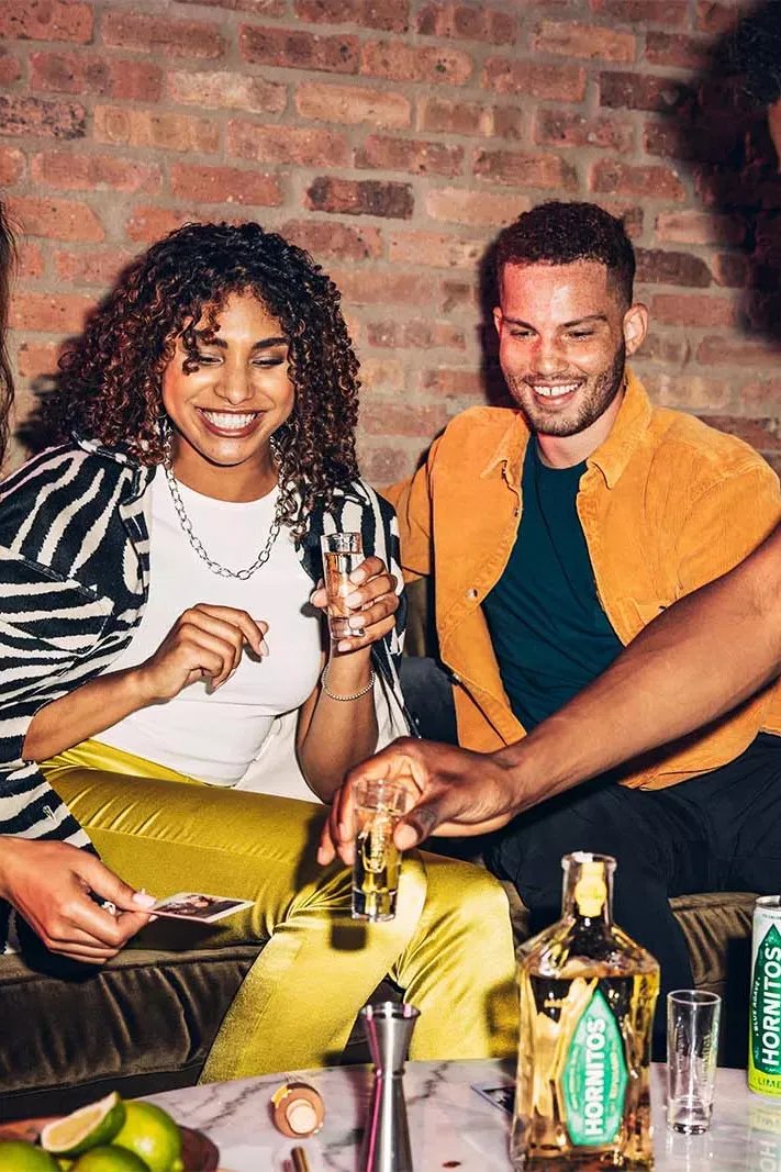 Friends Celebrating Indoor Gathering Tequila Shots Hornitos